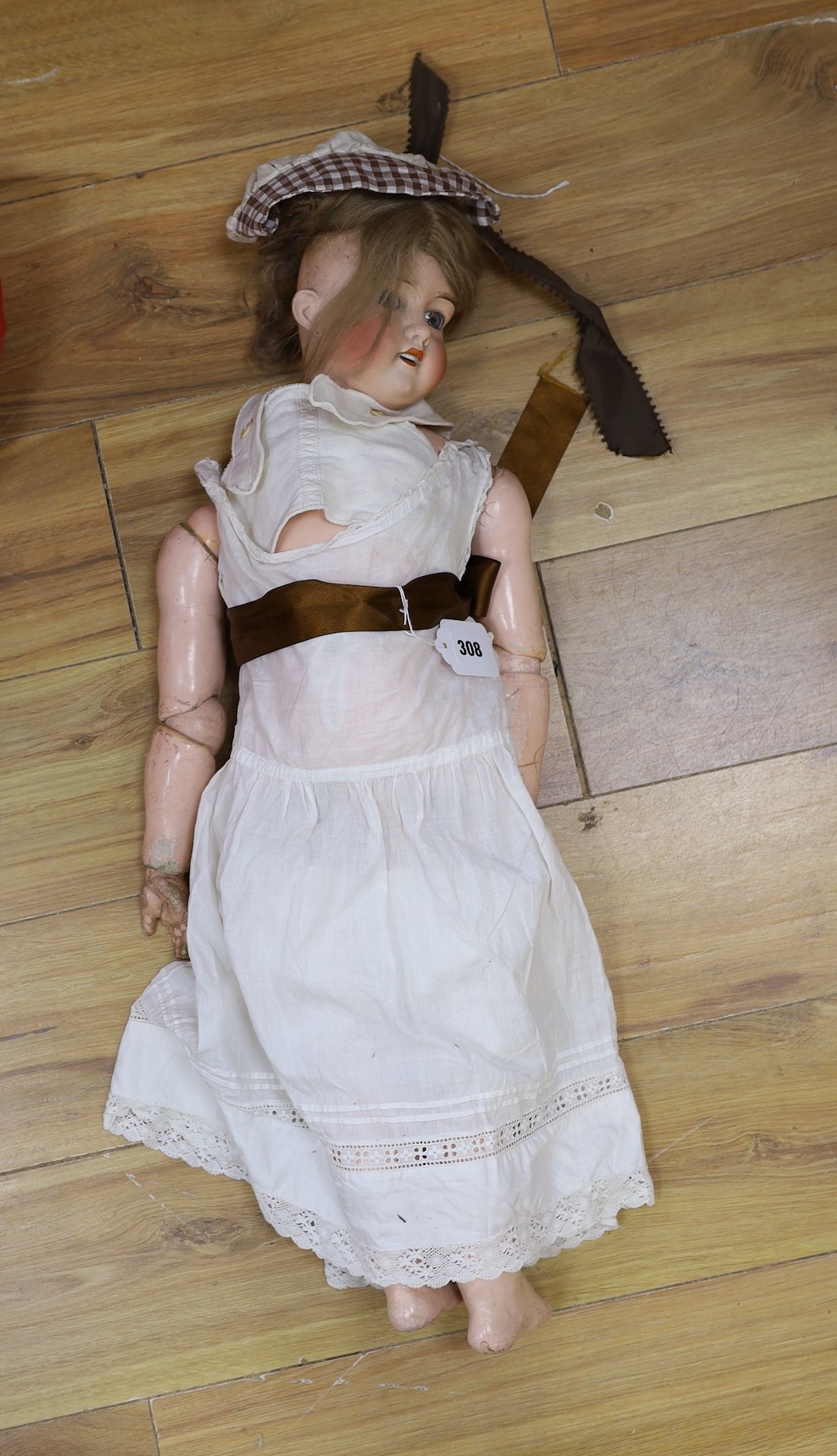 An early 20th century Lanternier & Cie, Limoges France bisque head doll, Cherie no. 11 and a another bisque head doll marked 13, limbs incomplete